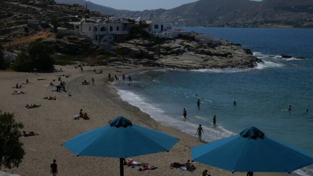 Sandy beach with blue umbrellas